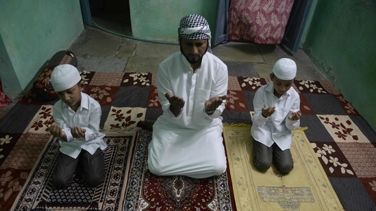 A Muslim family offers prayers during Eid-al-Fitr, in Hyderabad on May 14. In Hyderabad, Mecca Masjid was closed for the public as the administration has asked to offer prayers at home due to a Covid-19 induced lockdown. However, there is a relaxation in lockdown from 6 to 10 pm, ANI reported.(Noah Seelam / AFP)