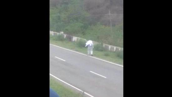 A video grab of the man carrying the body of his mother, who died due to Covid-19, for cremation on his shoulder after villagers and relatives refused to help at Bhangwar village in Dharamshala on Thursday.
