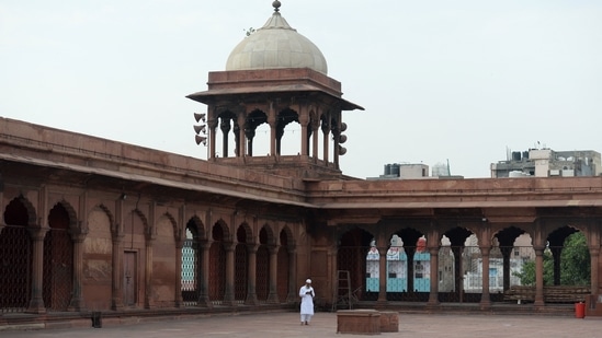 A Muslim devotee walks along the deserted courtyard of the Jama Masjid during Eid-al-Fitr festival, in New Delhi on May 14. Unlike the pre-corona times when at least 15,000-18,000 people gathered to offer the namaz in one of the country’s largest mosques, the Jama Masjid stayed shut to avoid crowding and only the Shahi Imam Syed Ahmed Bukhari and the mosque staff offered namaz inside the Mughal-era monument.(Arun Sankar / AFP)