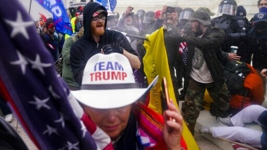 The House impeached Trump one week after the insurrection for telling his supporters to “fight like hell” in a speech just before the attack. (AP / File) The House impeached Trump one week after the insurrection for telling his supporters to “fight like hell” in a speech just before the attack. (AP / File)