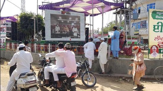 Locals watching the state-level virtual function to mark Eid-ul-Fitr on a big screen in Malerkotla town on Friday. HT Photo Locals watching the state-level virtual function to mark Eid-ul-Fitr on a big screen in Malerkotla town on Friday. HT Photo