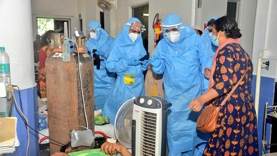 Goa chief minister Pramod Sawant (right), wearing a personal protective equipment suit, speaks to Covid-19 patients at the Goa Medical College and Hospital.