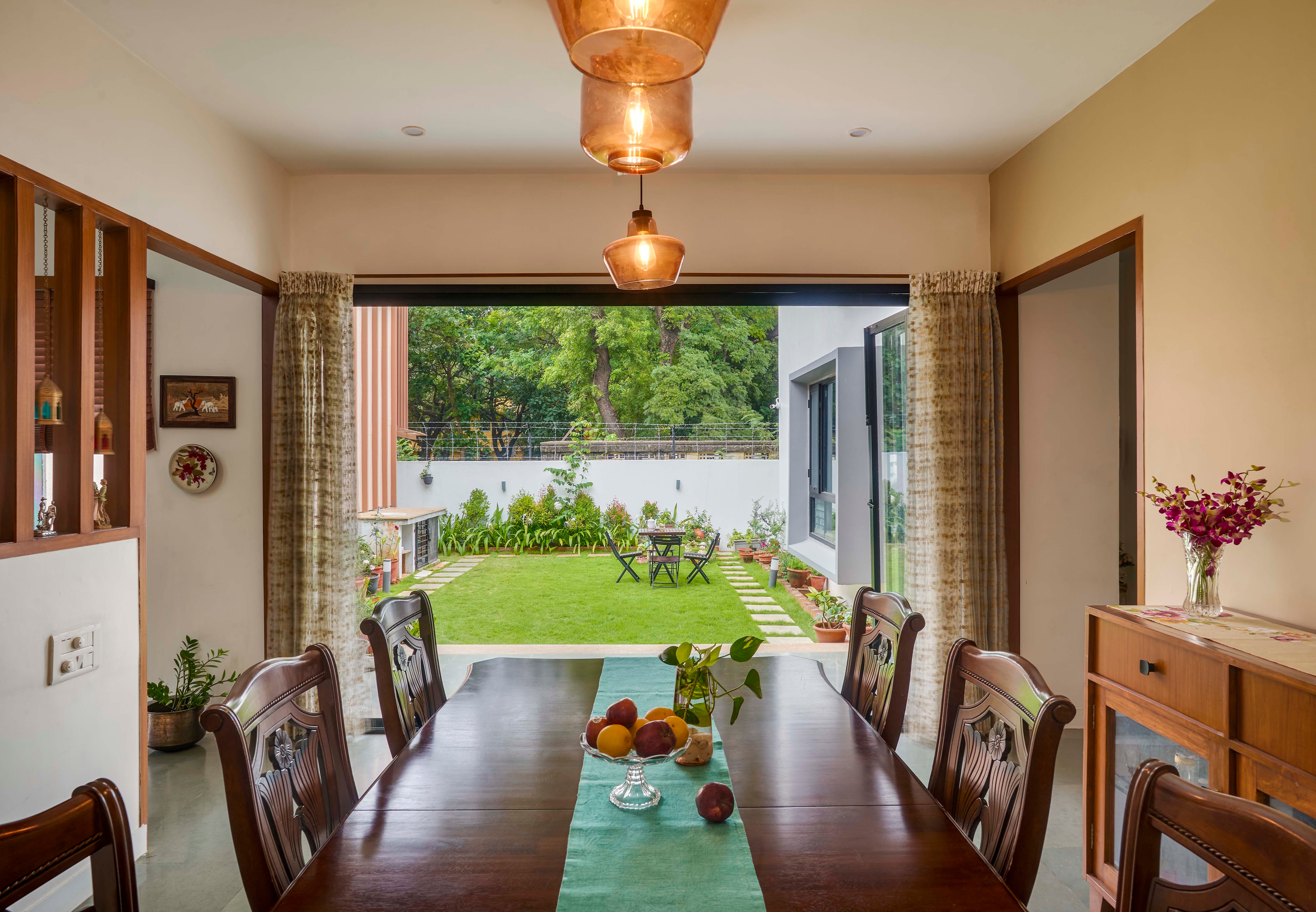 The two-storey, 4,200-sq-ft home of flowing spaces and natural light faces a lush lawn and garden that act as a physical extension of the dining space and a visual extension of the living area and four bedrooms. (Photos: Shamanth Patil J) The two-storey, 4,200-sq-ft home of flowing spaces and natural light faces a lush lawn and garden that act as a physical extension of the dining space and a visual extension of the living area and four bedrooms. (Photos: Shamanth Patil J)