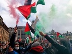 People hold Palestinian flags and flares during a demonstration in Lille, northern France. People hold Palestinian flags and flares during a demonstration in Lille, northern France.