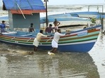 People shift fishing boats from the seashore of Kozhikode ahead of cyclone Tauktae(PTI) People shift fishing boats from the seashore of Kozhikode ahead of cyclone Tauktae(PTI)