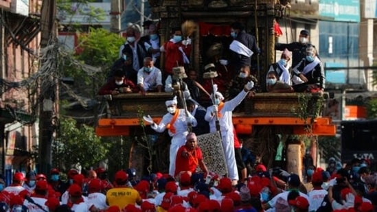This year, only around a hundred hand-picked devotees were allowed to pull the chariot for just a few meters (yards), as riot police sealed off the neighbourhood to prevent any spectators from entering. (AP Photo/Niranjan Shrestha) (AP) This year, only around a hundred hand-picked devotees were allowed to pull the chariot for just a few meters (yards), as riot police sealed off the neighbourhood to prevent any spectators from entering. (AP Photo/Niranjan Shrestha) (AP)