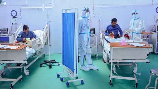 Health workers inspect Covid-19 patients at the Ramlila Maidan Covid Care Centre near LNJP hospital, New Delhi on May 15. Delhi recorded 8,506 new cases of Covid-19 on May 14, the lowest since April 10, with a nearly four-week long lockdown in the Capital finally bringing its overburdened health infrastructure some breathing room, HT reported.(Ravi Choudhary / PTI)