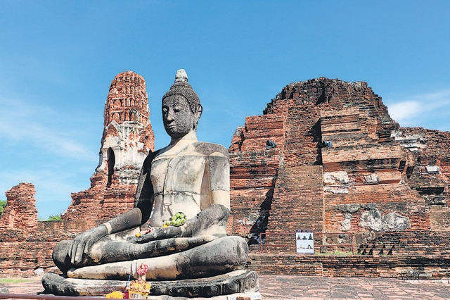 In Ayutthaya, Thailand, the Wat Mahathat Buddhist temple site draws pilgrims from around the world. (Shutterstock)