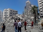 People insect the the rubble of the Yazegi residential building that was destroyed by an Israeli airstrike, in Gaza City. People insect the the rubble of the Yazegi residential building that was destroyed by an Israeli airstrike, in Gaza City.