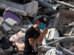 A Palestinian man prays amid the rubble of buildings destroyed in deadly Israeli airstrikes waiting for possible survivors to be rescued, in Gaza City. A Palestinian man prays amid the rubble of buildings destroyed in deadly Israeli airstrikes waiting for possible survivors to be rescued, in Gaza City.