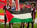 Leicester players Hamza Choudhury and Wesley Fofana with a Palestine flag after their win over Chelsea in the final of FA Cup(Twitter/Palestine in the UK) Leicester players Hamza Choudhury and Wesley Fofana with a Palestine flag after their win over Chelsea in the final of FA Cup(Twitter/Palestine in the UK)