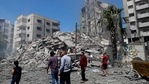 People insect the the rubble of the Yazegi residential building that was destroyed by an Israeli airstrike, in Gaza City.(AP) People insect the the rubble of the Yazegi residential building that was destroyed by an Israeli airstrike, in Gaza City.(AP)