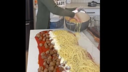 The image shows a woman showing the viral spaghetti hack.