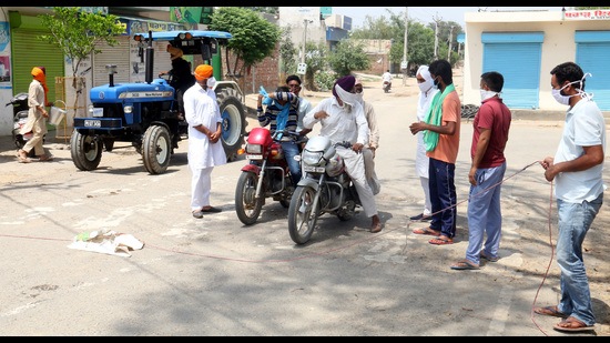 Residents enquiring about people coming to Bhokhra village in Mansa’s neighbouring Bathinda district . Residents enquiring about people coming to Bhokhra village in Mansa’s neighbouring Bathinda district .