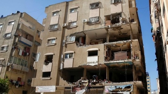A Palestinian man inspects a damaged apartment in the aftermath of Israeli airstrikes in Gaza City (Reuters).
