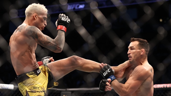 Charles Oliveira lands a kick against Michael Chandler during UFC 262 at Toyota Center.(USA TODAY Sports)