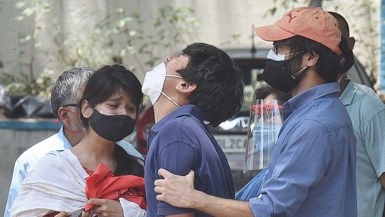 Relatives of a Covid-19 victim seen outside the mortuary at Lok Nayak Jai Prakash (LNJP) hospital in New Delhi.(Hindustan Times)