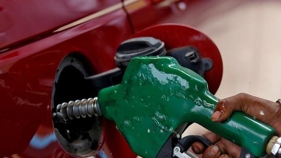 A worker holds a nozzle to pump petrol into a vehicle at a fuel station in Mumbai, India (File Photo / Representational Image).