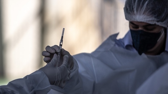 Healthcare workers prepare a dose of the Oxford-Astrazeneca Plc. Covid-19 vaccine, manufactured by Fiocruz, during a mass vaccination event in Botucatu, Brazil, on Sunday, May 16, 2021. A total of 57.1 million Covid vaccine doses have now been administered in Brazil, with an estimated rate of 945,574 doses per day. Photographer: Jonne Roriz/Bloomberg(Bloomberg) Healthcare workers prepare a dose of the Oxford-Astrazeneca Plc. Covid-19 vaccine, manufactured by Fiocruz, during a mass vaccination event in Botucatu, Brazil, on Sunday, May 16, 2021. A total of 57.1 million Covid vaccine doses have now been administered in Brazil, with an estimated rate of 945,574 doses per day. Photographer: Jonne Roriz/Bloomberg(Bloomberg)