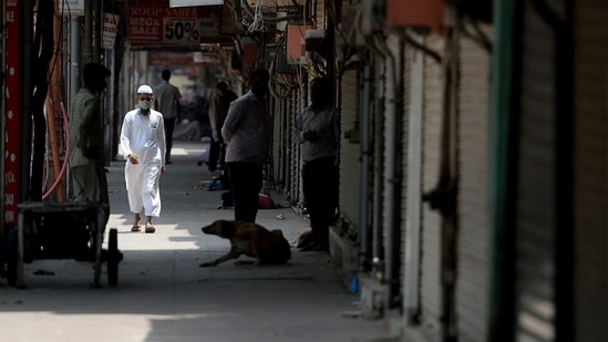 A man walks past closed shops during a lockdown imposed by the government amidst rising Covid-19 coronavirus cases, in New Delhi.(AFP)