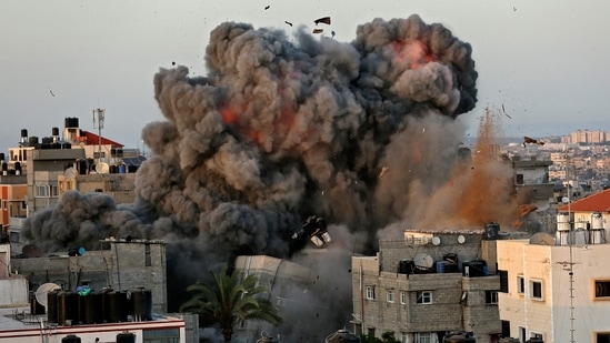 A ball of fire and thick smoke erupts from a building in Gaza City's Rimal residential district.(AFP)