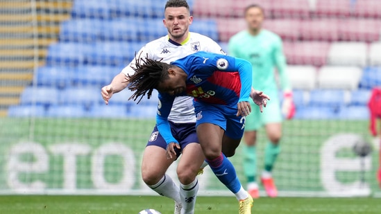 Crystal Palace's Eberechi Eze, front, and Aston Villa's John McGinn battle for the ball.(AP)