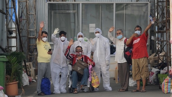 A patient with his relatives and healthcare workers poses for a photo after he gets discharged from BKC Jumbo Covid-19 hospital, in Bandra on Saturday. (PTI Photo) A patient with his relatives and healthcare workers poses for a photo after he gets discharged from BKC Jumbo Covid-19 hospital, in Bandra on Saturday. (PTI Photo)