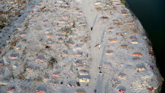 Bodies of the deceased buried under the sand during the second wave of Covid-19 pandemic, near the banks of Ganga river, in Prayagraj, Saturday, May 15, 2021. (PTI)