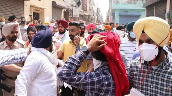 Supporters of MLA Simarjeet Singh Bains and district Youth Akali Dal president Gurdeep Singh Gosha clashing at Janta Nagar in Ludhiana on Sunday. (HT Photo) Supporters of MLA Simarjeet Singh Bains and district Youth Akali Dal president Gurdeep Singh Gosha clashing at Janta Nagar in Ludhiana on Sunday. (HT Photo)