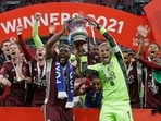 Leicester's goalkeeper Kasper Schmeichel, right, and Wes Morgan hold the trophy aloft at the end of the FA Cup final.(AP) Leicester's goalkeeper Kasper Schmeichel, right, and Wes Morgan hold the trophy aloft at the end of the FA Cup final.(AP)