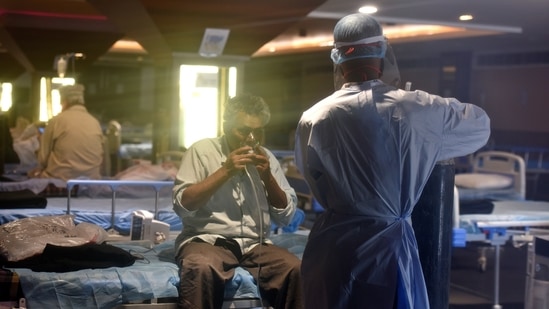 A patient breathes with the help of an oxygen mask at Shehnai Banquet Hall Covid-19 Care Centre attached to LNJP Hospital, in New Delhi on May 16. India's daily spike of coronavirus cases remained below the 3 lakh mark for the first time in nearly 26 days as only 2,81,386 fresh infections were recorded in the last 24 hours, according to the Union Health Ministry's data on May 17. A patient breathes with the help of an oxygen mask at Shehnai Banquet Hall Covid-19 Care Centre attached to LNJP Hospital, in New Delhi on May 16. India's daily spike of coronavirus cases remained below the 3 lakh mark for the first time in nearly 26 days as only 2,81,386 fresh infections were recorded in the last 24 hours, according to the Union Health Ministry's data on May 17.