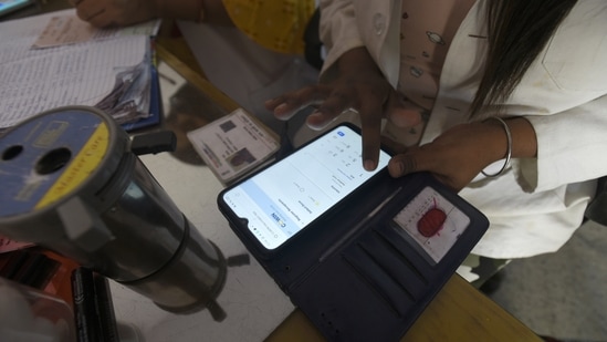 A health worker registering a person on the CoWin app for Covid-19 vaccination, at sector 22 (UPHC) urban primary health centre, in Noida, India, on Thursday, March 25, 2021. (Photo by Sunil Ghosh / Hindustan Times)