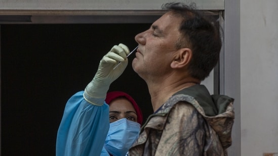 A health worker collects a nasal swab sample to test for Covid-19 in Srinagar on May 11. As per the Indian Council of Medical Research (ICMR), a total of 31,64,23,658 samples have been tested for Covid-19 up to May 16.(Dar Yasin / AP)