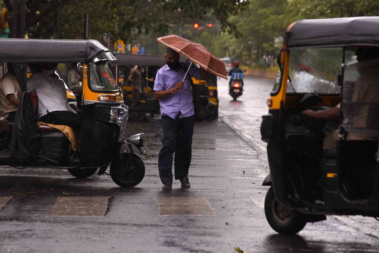 Commuters shield themselves from the rain in the wake of Cyclone Tauktae at Vashi Railway Station in Navi Mumbai on Monday, (Bachchan Kumar/ HT Photo)