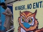 A pedestrian walks past a Covid-19 coronavirus awareness mural reading 'no mask, no entry' in Mumbai on May 12, 2021.(AFP Photo) A pedestrian walks past a Covid-19 coronavirus awareness mural reading 'no mask, no entry' in Mumbai on May 12, 2021.(AFP Photo)