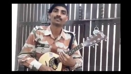 The image shows constable Rahul Khosla playing the mandolin.