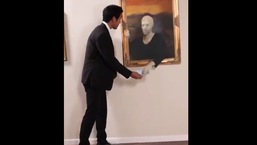 The image shows Zach King giving a mask to the paintings in a museum.