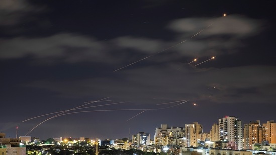 Streaks of light are seen as Israel's Iron Dome anti-missile system intercepts rockets launched from the Gaza Strip towards Israel.(Reuters)