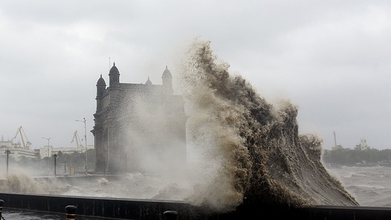 Waves crash over the promenade near the Gateway of India in Mumbai on May 17. In Maharashtra, at least six people were killed, PTI reported. Mumbai was lashed by heavy rain and strong winds, forcing authorities to suspend operations at the city’s main airport.(Sujit Jaiswal / AFP)