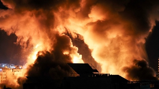 The sky is lit by an explosion above buildings in Gaza City as Israeli forces shell the Palestinian enclave, early on May 18, 2021. (AFP) The sky is lit by an explosion above buildings in Gaza City as Israeli forces shell the Palestinian enclave, early on May 18, 2021. (AFP)