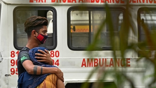 Relatives and family members mourn after they received the body of a patient who died of Covid-19 coronavirus at a mortuary in New Delhi on May 18, 2021. (AFP) Relatives and family members mourn after they received the body of a patient who died of Covid-19 coronavirus at a mortuary in New Delhi on May 18, 2021. (AFP)