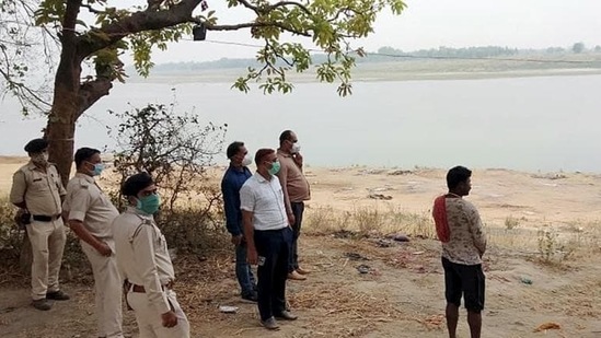 Police personnel looking buried in the ground dead bodies were found Mahadev Ghat on the banks of river Ganga in Chausa village, in Buxar (PTI file photo) Police personnel looking buried in the ground dead bodies were found Mahadev Ghat on the banks of river Ganga in Chausa village, in Buxar (PTI file photo)