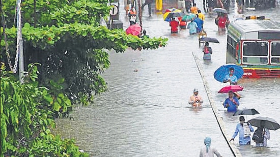 Commuters wade through a waterlogged street at Parel following heavy rainfall, in Mumbai in August, 2020. (HT archive) Commuters wade through a waterlogged street at Parel following heavy rainfall, in Mumbai in August, 2020. (HT archive)