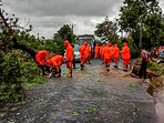 NDRF personnel clear a road, obstructed by felling of trees, after Cyclone Tauktae made landfall, in Gujarat.(PTI) NDRF personnel clear a road, obstructed by felling of trees, after Cyclone Tauktae made landfall, in Gujarat.(PTI)