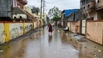 A woman walks along a flooded street after Cyclone Tautae hit the west coast of India.(AFP) A woman walks along a flooded street after Cyclone Tautae hit the west coast of India.(AFP)