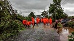 NDRF personnel clear a road, obstructed by felling of trees, after Cyclone Tauktae made landfall, in Gujarat. (PTI) NDRF personnel clear a road, obstructed by felling of trees, after Cyclone Tauktae made landfall, in Gujarat. (PTI)
