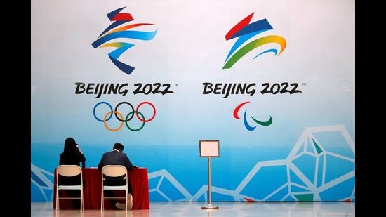 Staff members sit near a board with signs of the 2022 Olympic Winter Games, at the National Aquatics Center, known as the "Ice Cube", in Beijing, China. (REUTERS) Staff members sit near a board with signs of the 2022 Olympic Winter Games, at the National Aquatics Center, known as the "Ice Cube", in Beijing, China. (REUTERS)