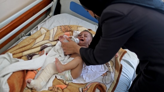 After the strikes, rescue workers pulled the five-month-old from the arms of his dead mother early Saturday, one of his tiny legs fractured in three places. REUTERS/Mohammed Salem (REUTERS)
