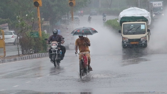 All Deputy Commissioners have been instructed to conduct regular monitoring, Dushyant Chautala said. In picture - Commuters crossing a waterlogged stretch of the road during heavy rains brought by Cyclone Tauktae in Jaipur.(HT Photo (Representational image))