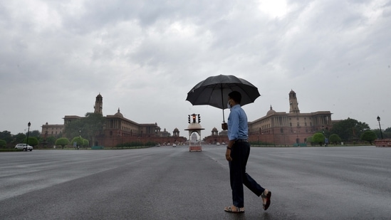 A man with an umbrella crossing Vijay Chowk on a rainy day in New Delhi, India, on Wednesday, May 19, 2021. (Arvind Yadav/HT Photo) A man with an umbrella crossing Vijay Chowk on a rainy day in New Delhi, India, on Wednesday, May 19, 2021. (Arvind Yadav/HT Photo)